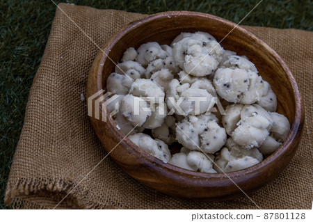 Thai Shortbread Cookies (Thai Dessert), Kanom Kleeb Lum Duen on burlap fabric background. Thai Shortbread Cookies (Thai Dessert), Kanom Kleeb Lum Duen on burlap fabric background. 87801128