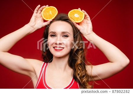 Beautiful woman in a red swimsuit with bright 87802282