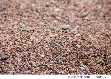 Small sea pebbles with stones with a reddish tint 87803079