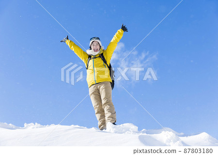 Young woman climbing a snowy mountain Image of climbing a snowy mountain 87803180