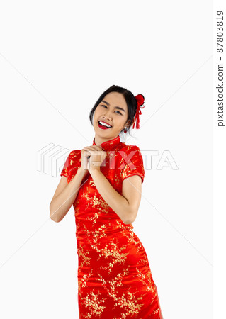 Chinese new year woman concept, happy asian woman wearing red Cheongsam dress isolated on white background. 87803819