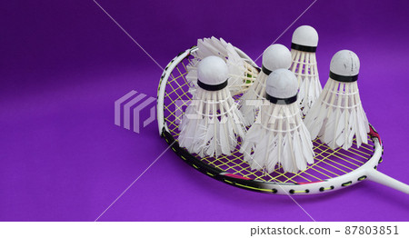 Unused badminton shuttlecocks and broken string racket on the floor of indoor badminton court, concept for badminton lovers around the world. Unused badminton shuttlecocks and broken string racket on the floor of indoor badminton court, concept for badminton lovers around the world. 87803851