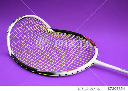 Unused badminton shuttlecocks and broken string racket on the floor of indoor badminton court, concept for badminton lovers around the world. 87803854