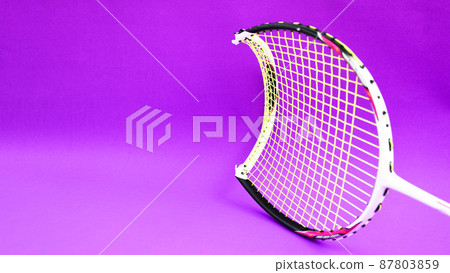 Unused badminton shuttlecocks and broken string racket on the floor of indoor badminton court, concept for badminton lovers around the world. 87803859