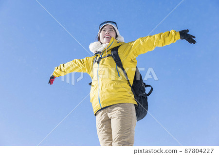 Young woman climbing a snowy mountain Image of climbing a snowy mountain 87804227