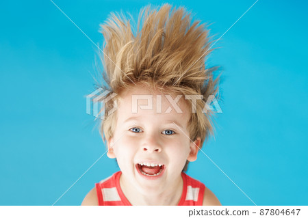 Happy child shouting against blue paper background 87804647