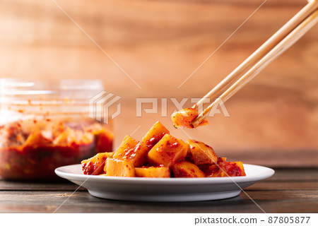 Kimchi radish eating by chopsticks, Korean homemade side dish food Kimchi radish eating by chopsticks, Korean homemade side dish food 87805877