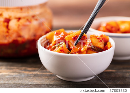 Kimchi radish eating by chopsticks, Korean homemade side dish food Kimchi radish eating by chopsticks, Korean homemade side dish food 87805880