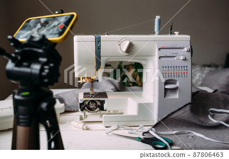 Shooting video of the sewing process, workshop on clothing design on smartphone Shooting video of the sewing process, workshop on clothing design on smartphone 87806463