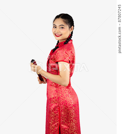 Asian girl holding chinese fan in red cheongsam costume isolated on white background. Chinese new year concept style.. Asian girl holding chinese fan in red cheongsam costume isolated on white background. Chinese new year concept style.. 87807245