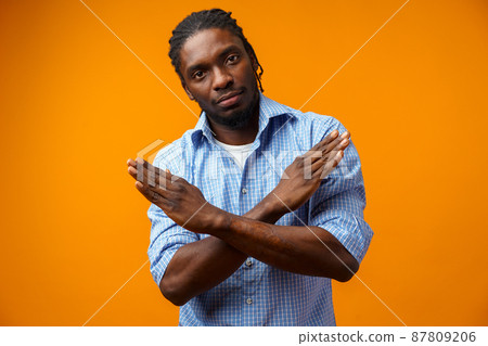 Portrait of serious African American male showing hand stop sign Portrait of serious African American male showing hand stop sign 87809206