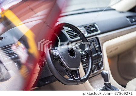 Modern luxury prestige car interior, dashboard, steering wheel. Orange red car interior. Modern luxury prestige car interior, dashboard, steering wheel. Orange red car interior. 87809271