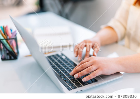 Young girl typing on laptop at home Young girl typing on laptop at home 87809836
