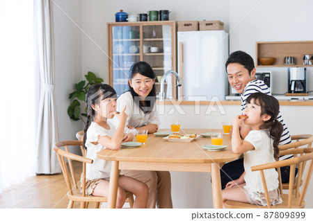 Young family eating snacks in the dining room 87809899