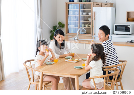 Young family eating snacks in the dining room 87809909