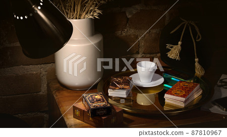 Blurred predictions background. Tarot cards layout on witch table. Blurred predictions background. Tarot cards layout on witch table. 87810967