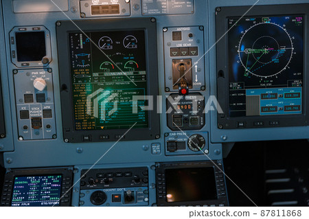 Airplane cockpit with control panel, dashboard and flight displays 87811868