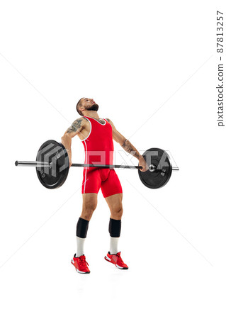 Full length portrait of man in red sportswear exercising with a weight isolated on white background. Sport, weightlifting, power, achievements concept Full length portrait of man in red sportswear exercising with a weight isolated on white background. Sport, weightlifting, power, achievements concept 87813257