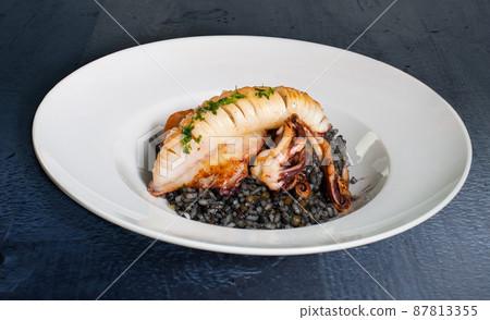 Grilled squid with black rice Grilled squid with black rice 87813355