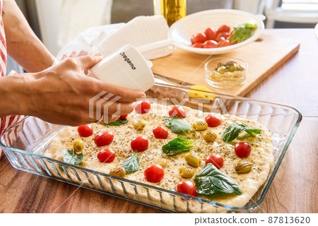 Woman cooking Italian focaccia bread at home. Selected fresh ingredients. Cooking process. Country Woman cooking Italian focaccia bread at home. Selected fresh ingredients. Cooking process. Country 87813620