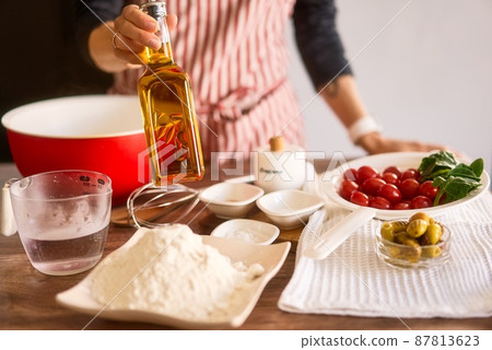 Woman cooking Italian focaccia bread at home. Selected fresh ingredients. Cooking process. Country 87813623