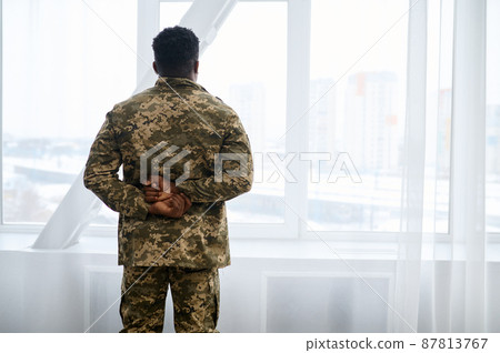 Back view on veteran looking out window Back view on veteran looking out window 87813767