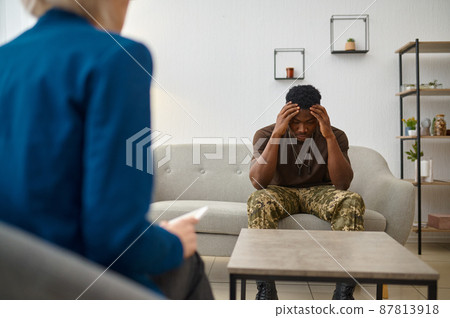 Frustrated military patient talking with doctor psychologist 87813918