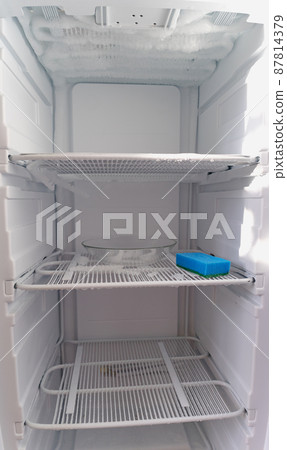 Domestic fridge freezer defrost problem concept. Refrigerator covered with ice. Appliance repair concept. Domestic fridge freezer defrost problem concept. Refrigerator covered with ice. Appliance repair concept. 87814379