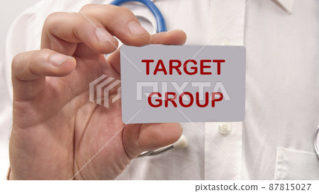 Target group the text on the card in the man's hand 87815027