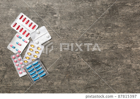 Protective face masks or surgical masks, medicine pills and thermometer on table background. Coronavirus disease. Corona virus concept. Space for text 87815397