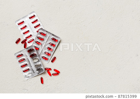 Protective face masks or surgical masks, medicine pills and thermometer on table background. Coronavirus disease. Corona virus concept. Space for text 87815399