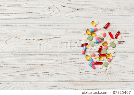 Protective face masks or surgical masks, medicine pills and thermometer on table background. Coronavirus disease. Corona virus concept. Space for text 87815407