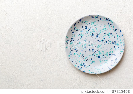 Top view of empty blue plate on cement background. Empty space for your design 87815408