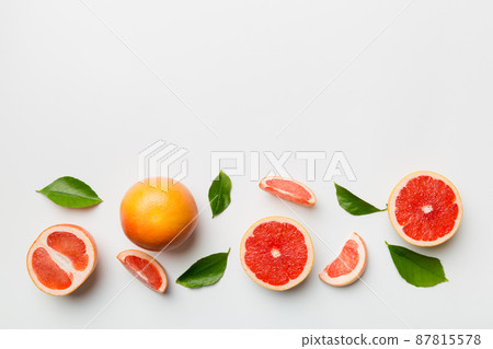 fresh Fruit grapefruit with Juicy grapefruit slices on colored background. Top view. Copy Space. creative summer concept. Half of citrus in minimal flat lay with copy space fresh Fruit grapefruit with Juicy grapefruit slices on colored background. Top view. Copy Space. creative summer concept. Half of citrus in minimal flat lay with copy space 87815578