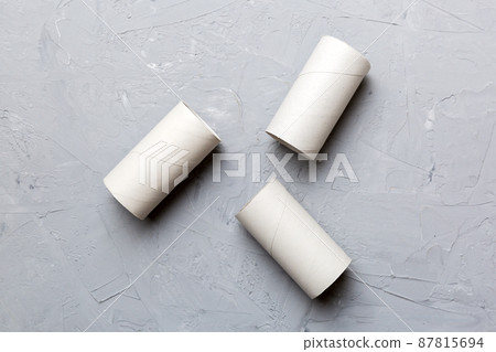 Flat lay composition with empty toilet paper rolls and space for text on color background. Recyclable paper tube with metal plug end made of kraft paper or cardboard 87815694