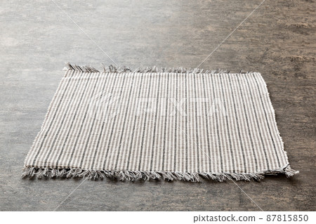Perspective view of grey tablecloth for food on cement background. Empty space for your design 87815850