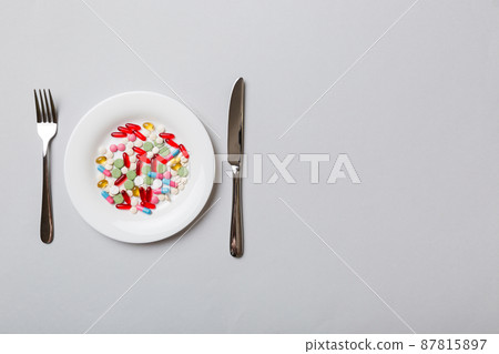 Many different weight loss pills and supplements as food on round plate. Pills served as a healthy meal. Drugs, pharmacy, medicine or medical healthycare concept Many different weight loss pills and supplements as food on round plate. Pills served as a healthy meal. Drugs, pharmacy, medicine or medical healthycare concept 87815897