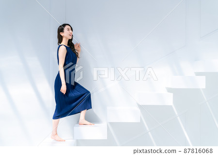 A young woman climbing the stairs A young woman climbing the stairs 87816068