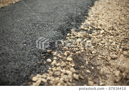 New asphalt. Construction of path in park. Details of road surface. 87816418