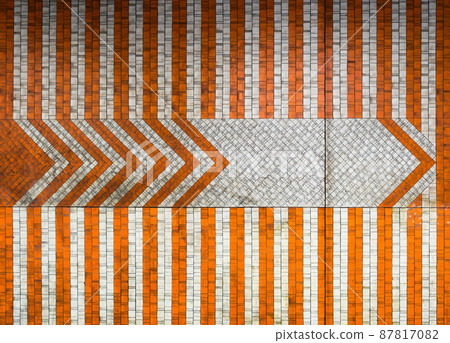 Laeken, Brussels Capital Region - Belgium - 09 25 2019 Abstract designed tiles with orange shaped arrows of the Pannenhuis metro Laeken, Brussels Capital Region - Belgium - 09 25 2019 Abstract designed tiles with orange shaped arrows of the Pannenhuis metro 87817082