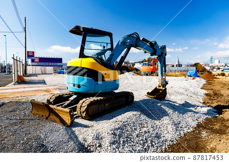 Construction site: Heavy equipment Mini Yumbo and clear blue sky 87817453