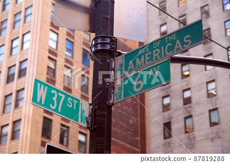 Green West 37th Street and Avenue of the Americas 6th traditional sign in Midtown Manhattan 87819288