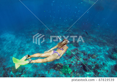 Young woman diving underwater 87819539
