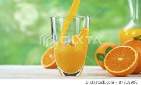 Fresh Orange Juice Being Poured in a Glass Fresh Orange Juice Being Poured in a Glass 87819906