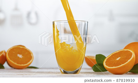 Fresh Orange Juice Being Poured in a Glass 87819910