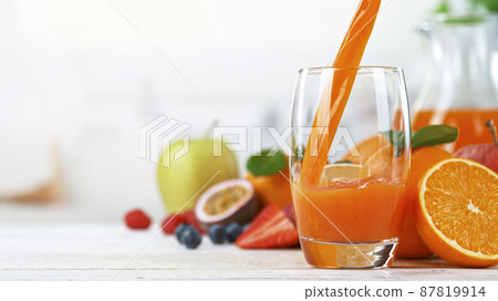 Fresh Multivitamin Juice Being Poured in a Glass 87819914