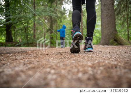 Woman in hiking boots on a trail 87819980