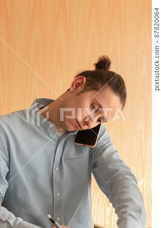 Portrait of a young businessman talking on the phone Portrait of a young businessman talking on the phone 87820064
