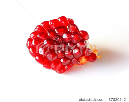 Red ripe pomegranate grains on white background. 87820242