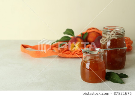 Peach jam and ingredients on white textured table Peach jam and ingredients on white textured table 87821675